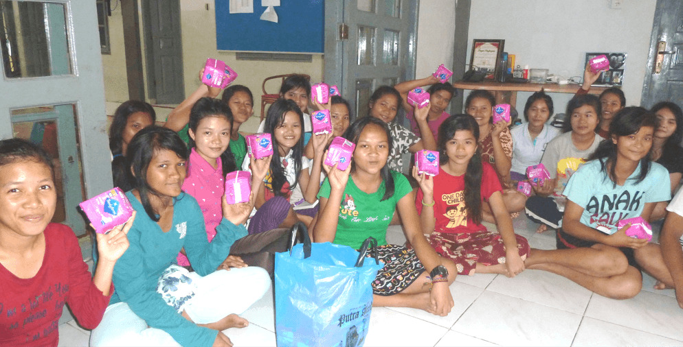 Young girls holding period pads